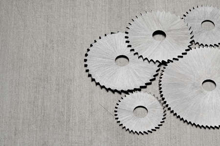 Metal disk saws on a metal tableの写真素材