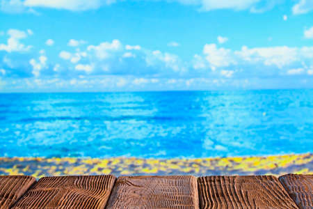 Wooden table with empty space on the beachの写真素材