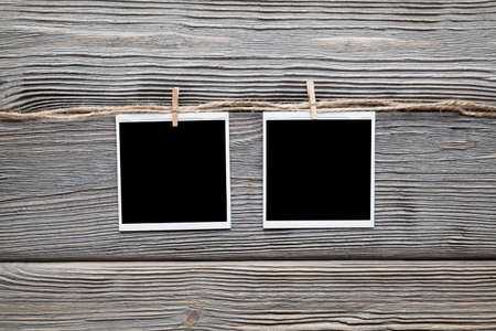 Two vintage photo frames with empty space on wooden backgroundの写真素材