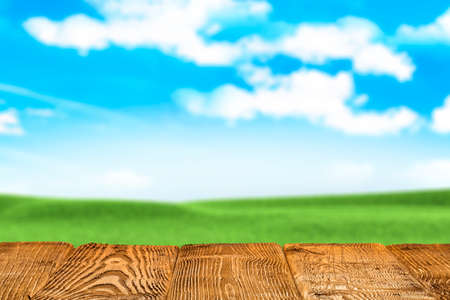 Wooden table with free space on nature landscape backgroundの写真素材