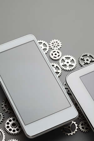 Modern smartphone and small gears on gray table