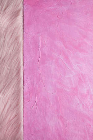 Double-layered background - pink plaster surface and pink fur