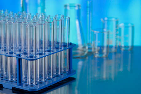 Laboratory test tubes as a symbol of medical tests on the metal table on blueの写真素材