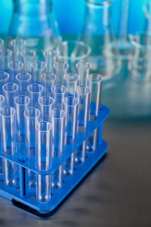 Laboratory test tubes as a symbol of medical tests on the metal table and blue