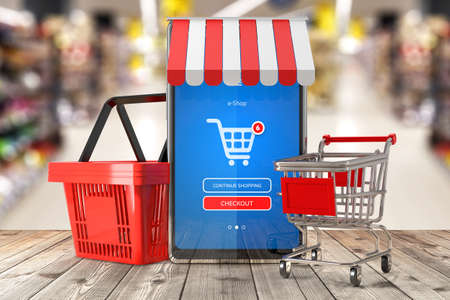 Smartphone with mobile e-shop application on screen. Shopping basket and shopping trolley cart on supermarket interior background. Symbol of online shopping and delivery - 3d illustrationの写真素材