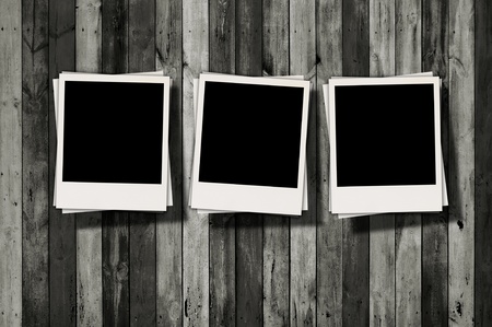 Three Blank Polaroids on Dark Wood Backgroundの写真素材