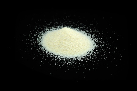 Pile of Semolina on Black Backgroundの写真素材