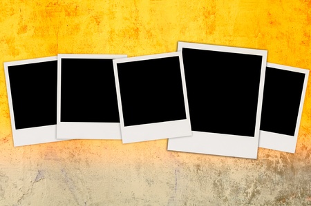 Five Blank Photos on Bright Concrete Wall