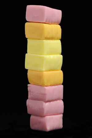 Stack of Sweet Juicy Fruit Chew Candies on Black Backgroundの写真素材