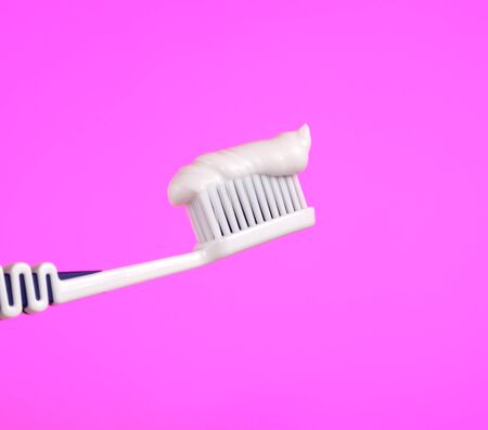 Toothbrush with Toothpaste on Pink Backgroundの写真素材