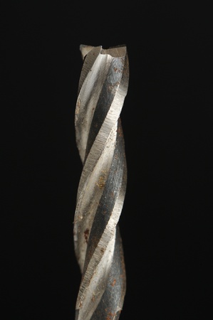 Old Rusty Drill Bit on Black Background
