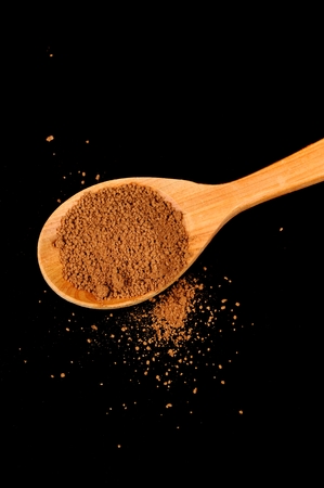 Wooden Spoon with Instant Cocoa Powder on Black Backgroundの写真素材