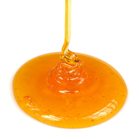 Pouring Honey on White Backgroundの写真素材