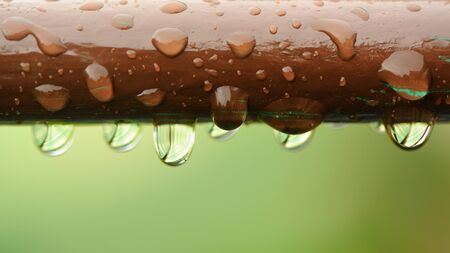 Water Drops on Brown Rail Close-Upの写真素材