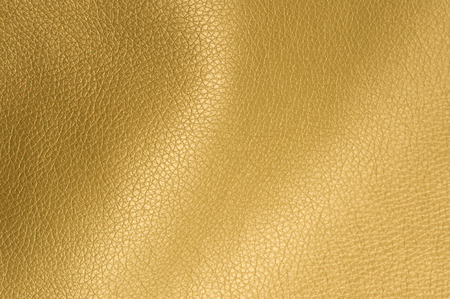 Golden Glossy Artificial Leather Background Texture Close-Up