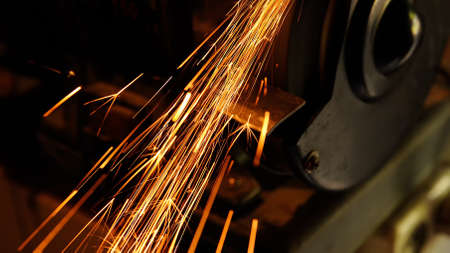 Glowing flow of sparks from working grinderの写真素材