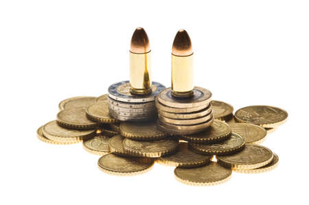 Pile of Euro coin currency with 9mm bullets isolated on white background. European money coins stack and ammo. War, conflict and crime bussines concept.の写真素材