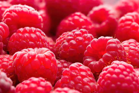 Fresh ripe red raspberries background close-up. Healthy organic food, summer vitamins, BIO viands,...