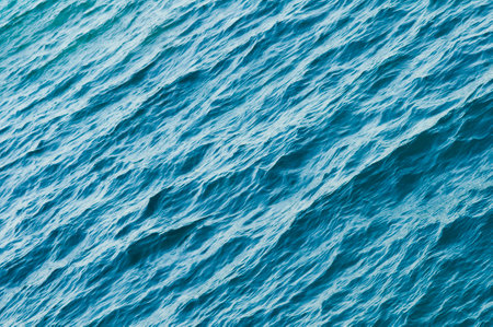 Ripple on the surface of the ocean water close-up. Blue sea background with waves. Caribbean lifestyle themes.の写真素材