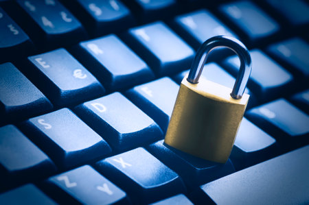 Locked metal padlock on blue computer keyboard. Data and password protection, internet and network...
