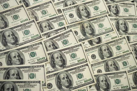 A money pile of one hundred US banknotes with president Franklin portrait. Cash of hundred dollar...