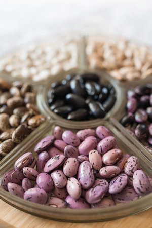 Shelled ripe seeds of kidney bean on heap. Sorted pile of dry raw seeds of haricot (Phaseolus...