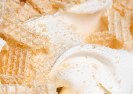 Frozen Creamy flavour gelato (called Russian Ice Cream) - full frame detail. Close up of a white surface texture of Ice cream covered with pieces of broken waffle.の写真素材