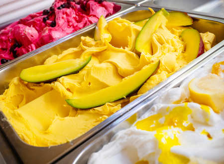 Various Gelato in a store window. Multicolor Ice cream rack in a snack bar close-up.
