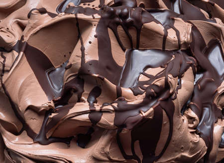 Chocolate flavour gelato - full frame detail. Close up of a brown surface texture of chocolate Ice cream covered with dark chocolate topping.の写真素材