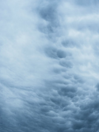 Dramatic blue sky with clouds. Spooky abstract background pattern texture. Horror, Halloween, evil, armagedon, apocalypse concept.の写真素材