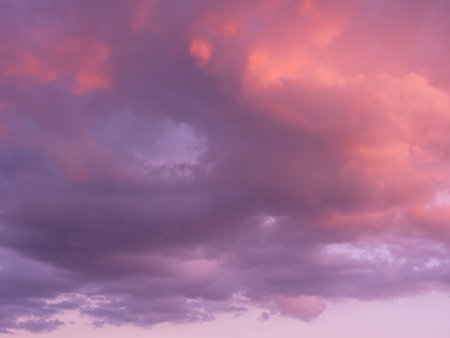 Dramatic sky with clouds. Mysterious abstract background pattern texture. Many blue and magenta tones and patterns of clouds.の写真素材