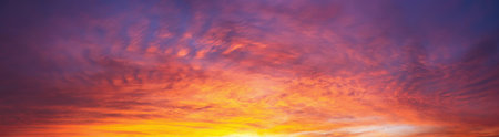 Dramatic dusk sky with clouds. Mysterious abstract heaven background pattern texture at sunset.  Wide banner panorama.の写真素材