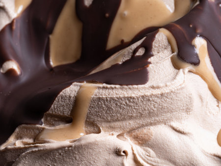 Frozen Toffifee flavour gelato - full frame detail. Close up of beige creamy surface texture of Ice cream covered with caramel and chocolate topping.の写真素材