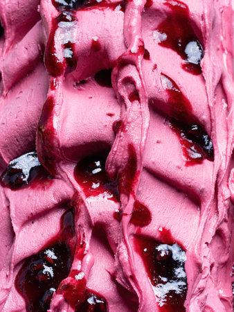 Frozen Pomegranate flavour gelato - full frame detail. Close up of a pink surface texture of Ice cream covered with  red syrup.の写真素材