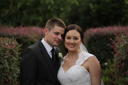 Bride and groom in the gardenの写真素材