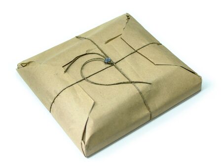 Brown paper parcel packet tied with rough twine and sealed by metal isolated on white background