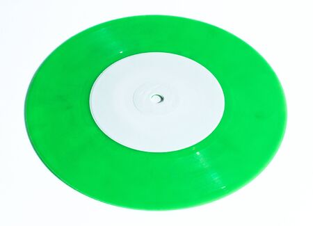 Seven inch single 45rpm green vinyl record with small hole isolated on white backgroundの写真素材