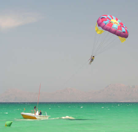 A boat pulling a parasailorの写真素材