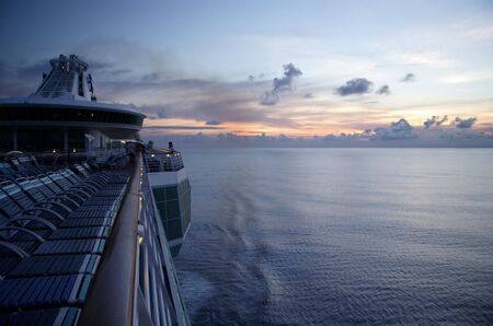 Large ship cruising into a caribbean sunset