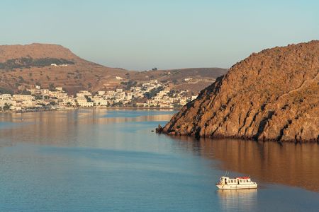 Excursion boat cruising in the morning sunの写真素材