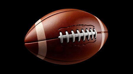 American football ball isolated on black background. 3D rendering image.の素材