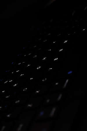 Image of black keyboard that has white and blue led lightsの写真素材