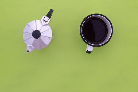 top view of espresso pot and coffee cup on green backgroundの写真素材
