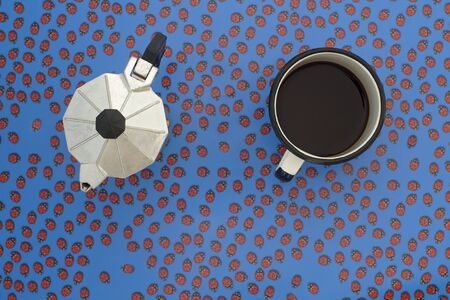 top view of espresso pot and coffee cup with ladybugs backgroundの写真素材