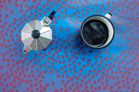 top view of espresso pot and coffee cup with ladybugs backgroundの写真素材