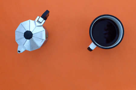 top view of espresso pot and coffee cup on orange backgroundの写真素材