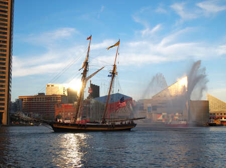 BALTIMORE, MD -  SEPTEMBER 10, 2014: Tall ship Pride of Baltimore and a Baltimore City fire boat celebrate the 200th anniversary of America's national anthem, The Star Spangled Banner, in the Inner Harbor in Baltimore, MD, as part of the Star Spangled Speのeditorial素材