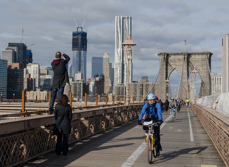 Brooklyn, NY, USA - January 8, 2012 - Bicycle Riders and Tourists enjoying a day on the Brooklyn Bridge.のeditorial素材