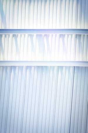 Geometric background with a building structure with elements creating straight lines. Abstract vertical template on the theme of architecture and construction.の写真素材