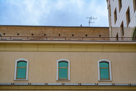 The facade of the old building in the winter under the snow